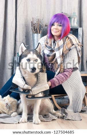 dog with ice skates and joyful attractive woman
