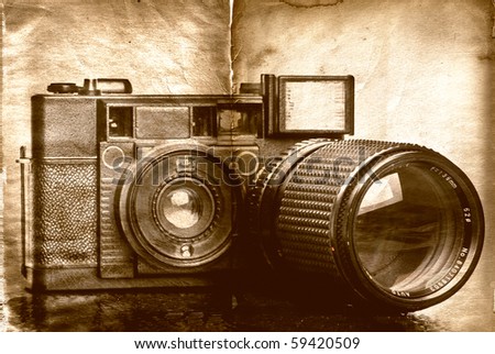 Vintage folding camera with a grunge texture of scratches added for effect