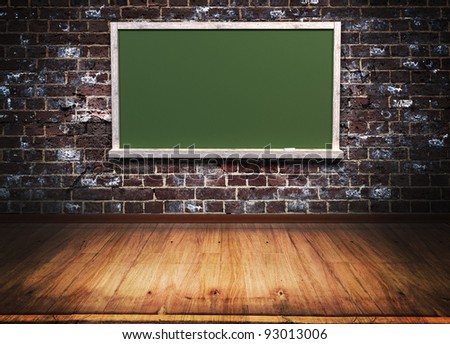 green blackboard with wooden frame on brick wall