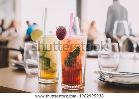 Similar – Foto Bild Zwei Mojito-Cocktails mit gealtertem Rum, Minze und verschiedenen Früchten. Einer mit Erdbeere und der andere mit Passionsfrucht