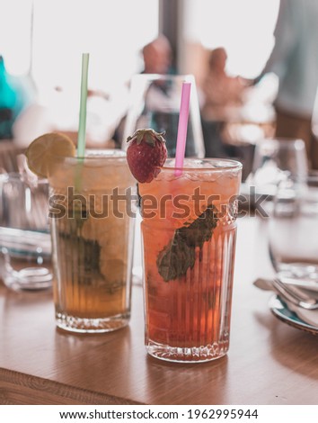 Similar – Foto Bild Zwei Mojito-Cocktails mit gealtertem Rum, Minze und verschiedenen Früchten. Einer mit Erdbeere und der andere mit Passionsfrucht