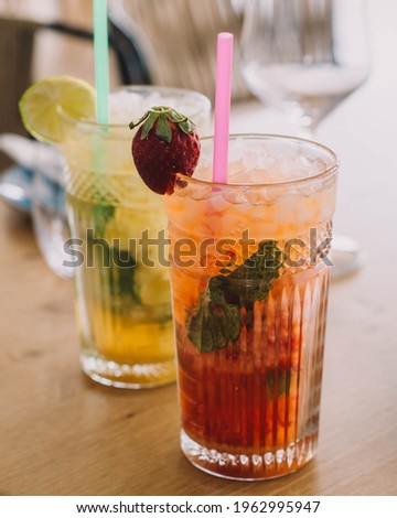 Similar – Foto Bild Zwei Mojito-Cocktails mit gealtertem Rum, Minze und verschiedenen Früchten. Einer mit Erdbeere und der andere mit Passionsfrucht