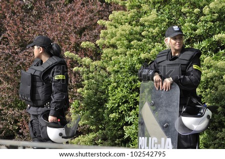 WARSAW, POLAND - MAY 11: Policewomen in riot gear, protecting a parliament building, during a protest of the Solidarity trade union against the pension reform on May 11, 2012 in Warsaw, Poland.