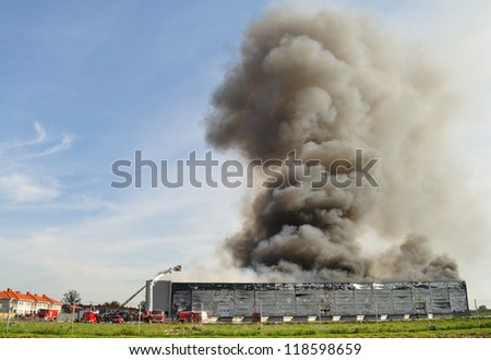 WOLKA KOSOWSKA, POLAND - MAY 10: Smoke rising from a raging fire in a China Mart storehouse, May 10, 2011 in Wolka Kosowska, Poland. The fire burned 150 storage units covering nearly 2 hectares.
