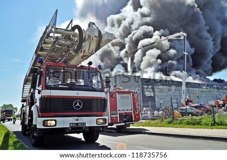 WOLKA KOSOWSKA, POLAND - MAY 10: Firefighters extinguish a raging fire in a China Mart storehouse, May 10, 2011 in Wolka Kosowska, Poland. The fire burned 150 storage units covering nearly 2 hectares