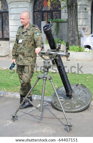 WARSAW - AUGUST 15: Soldier presenting a mortar, during celebrations of the Polish Armed Forces Day on August 15, 2010 in Warsaw, Poland.