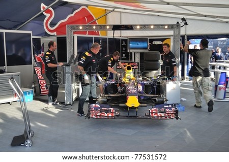 WARSAW - SEPTEMBER 04: Red Bull Racing mechanics, working on Mark Webber\'s car, after his demonstration ride, during the \