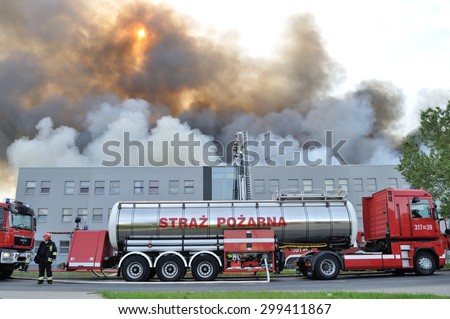 Wolka Kosowska, Poland - May 10, 2011: Water tender fire truck, during extinguish a raging fire in a China Mart storehouse. The fire burned 150 storage units covering nearly 2 hectares.