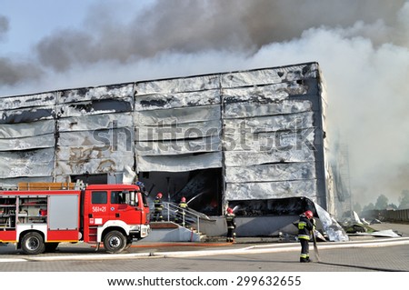 WOLKA KOSOWSKA, POLAND - MAY 10, 2011: Firefighters extinguish a raging fire in a China Mart storehouse. The fire burned 150 storage units covering nearly 2 hectares.