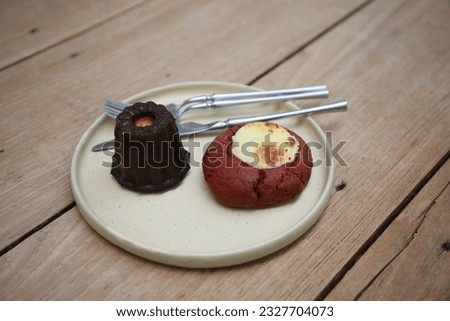 Canale, spoon and fork placed in a ceramic tray c on brown wooden table Stok fotoğraf © 
