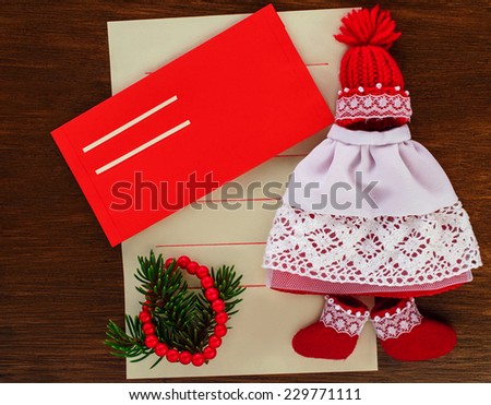 Letter to Santa Claus with a red envelope. Styling toys using red hat, boots and lace skirt