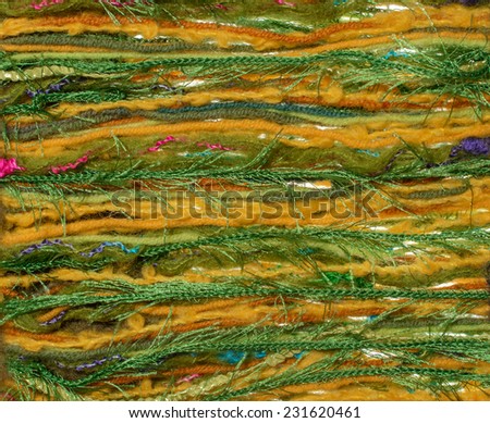 Green  fabric texture of wool with stick out yarn. Craft background