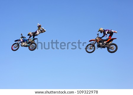 MOSCOW, RUSSIA - JULY 28 : Luzhniki, Alexey Kolesnikov and Alexey Aysin perform motorcycle stunt tricks at Freestyle Motocross session during Moscow City Games on July 28, 2012 in Moscow.