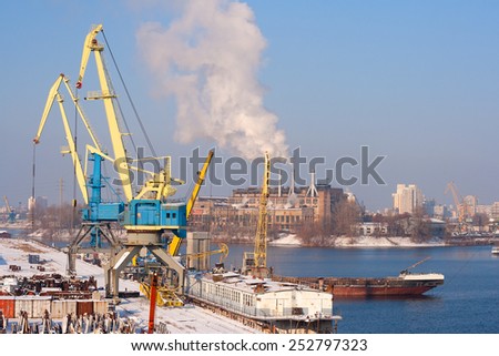 Aerial view to empty cargo dock with cranes and containers