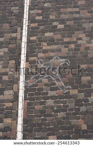 Outline of a person that has been lying dead on the floor of a crime scene