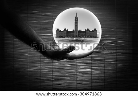 Human Hand Holding a White Sphere Bamboo Background shot in black and white