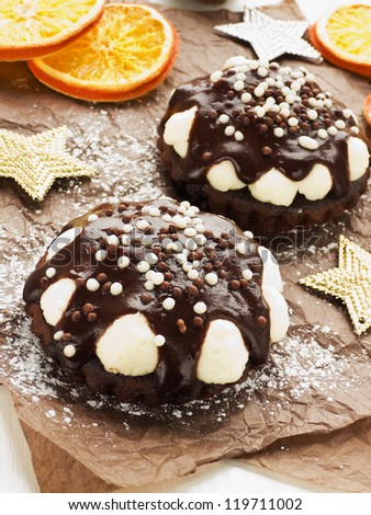 Christmas dessert chocolate tarts with whipped cream and glaze. Shallow dof.