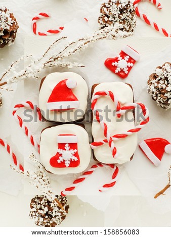 Chocolate cakes with whipped cream and christmas decorations. Viewed from above.