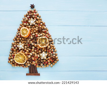 Christmas tree made of nuts, cinnamon and anise. Viewed from above.