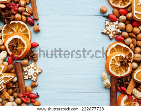 Christmas background nuts, dried oranges, spices and gingerbread cookies. Viewed from above.