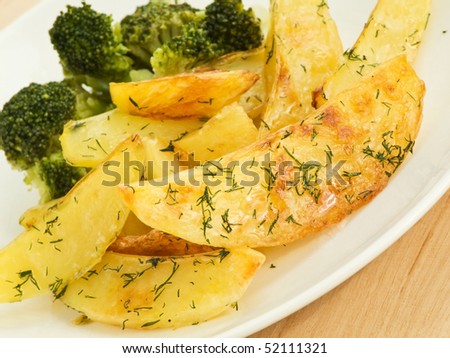 Baked potatoes wedges with broccoli. Shallow dof.