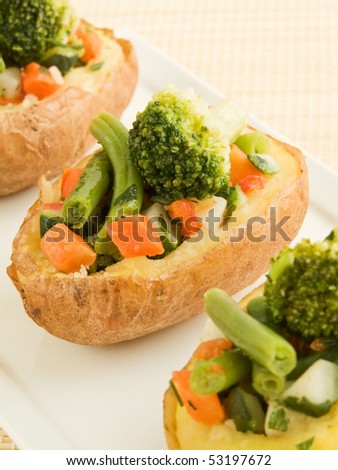 Plate with baked potatoes stuffed with vegetables. Shallow dof.