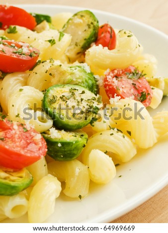 Italian pasta cavatappi with brussels sprouts and cherry tomatoes. Shallow dof.