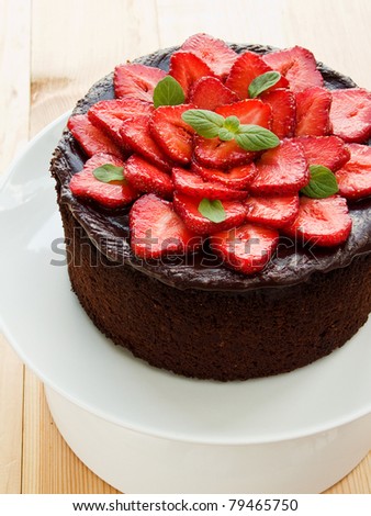 Homemade chocolate cake with strawberry and mint. Shallow dof.