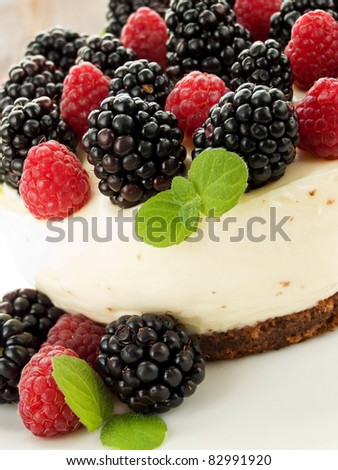 Sour cream cheesecake with raspberries and blackberries. Shallow dof.