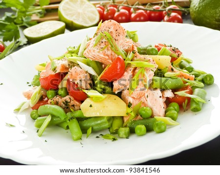 Salad with salmon, potato and other veggies. Shallow dof.