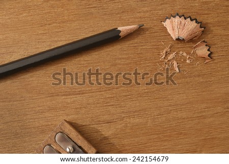 PENCIL SHARPENING.  A close up of a sharpened pencil on a desk