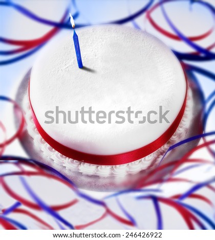 BIRTHDAY CAKE - A shot of a birthday cake with single candle and red and whit ribbons.  Room to write a message