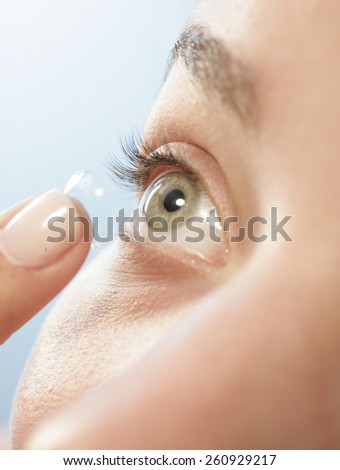 CLOSE UP OF EYE LOOKING UP- A close up at an angle of a female putting in a contact lens into her eye