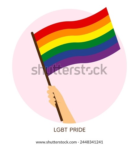 Hand holding rainbow pride flag