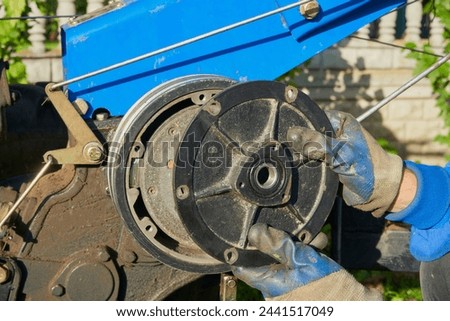 Similar – Image, Stock Photo Farmer repairing detail of agricultural machine