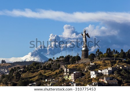 Cotopaxi volcano eruption and Panecillo\'s Madona seen from Quito, Ecuador