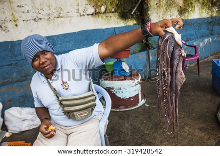 SANTO DOMINGO, ECUADOR - APRIL 15, 2010: Unidentified man selling octopus seafood market in Santo Domingo, Ecuador.