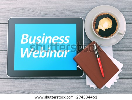 Business Webinar text on the screen of Digital Tablet PC. Workspace on wooden background. Top view