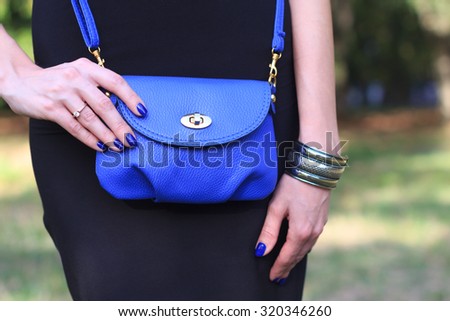 Young fashion woman hold handbag clutch