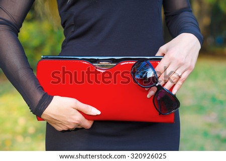 Fashion woman hold red handbag clutch