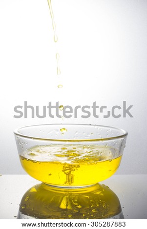 pouring yellow drink splash into glass on white background