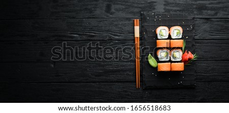 Traditional sushi - Philadelphia with salmon, avocado and cheese. Japanese cuisine. Top view.