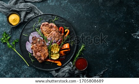 Beef steak. Juicy veal steak with rosemary and spices. Top view. Barbecue.