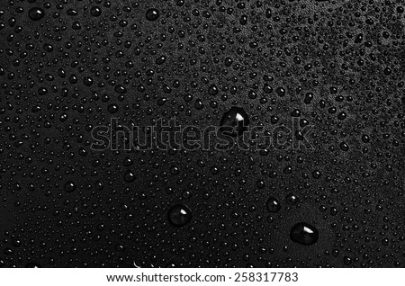 water drops on a black plastic surface