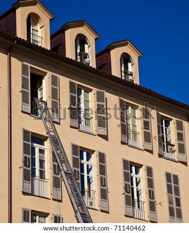 Ladder used to move furniture with elegant palace in background