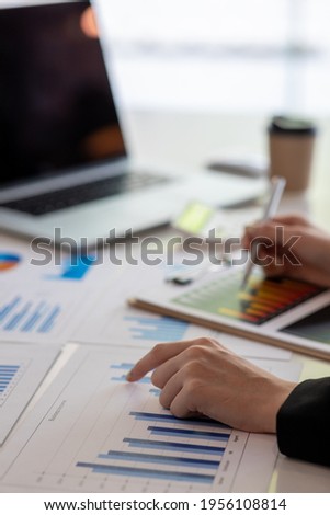 Financial Business woman analyze the graph of the company's performance to create profits and growth, Market research reports and income statistics, data,repotr,Financial and Accounting concept.