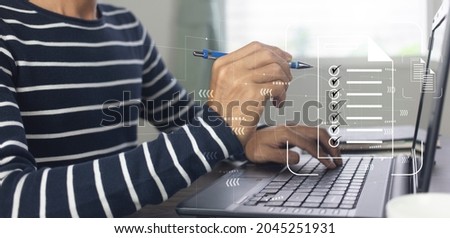 person working on laptop and management with document check list at work place,business office process system concept Foto stock © 