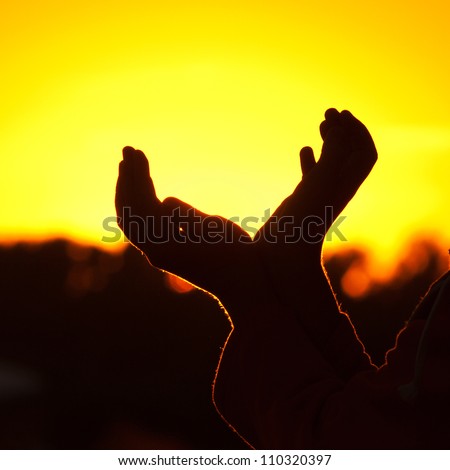 little girl holding in hands the setting sun