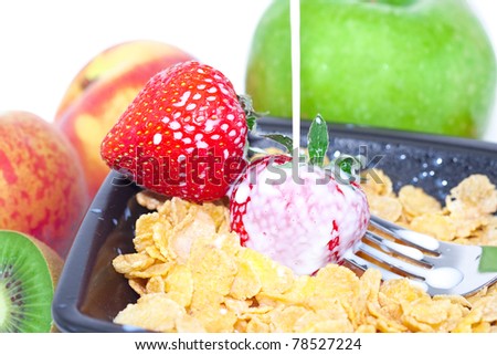 strawberry, peach, apple, kiwi, fork, milk and flakes in a bowl isolated on white