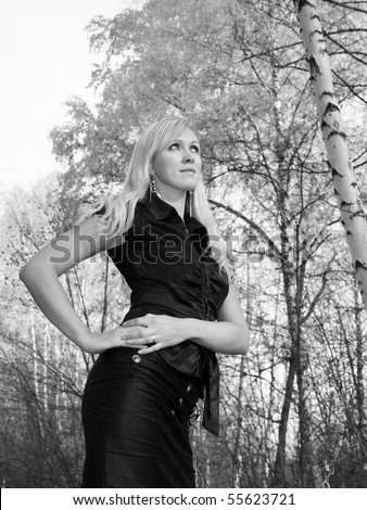 Romance meeting with young women in autumn forest. Black and white photo